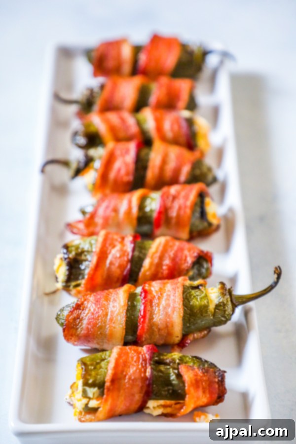 picture of bacon wrapped jalapeno poppers on a plate