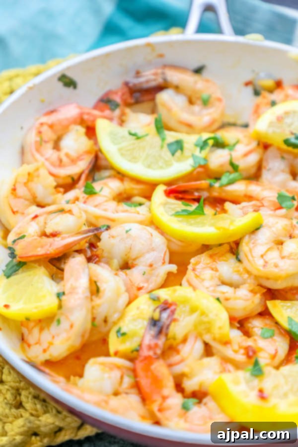 Sizzling Lemon Garlic Shrimp 3 Lemon garlic butter shrimp cooking in a skillet, showcasing the quick 15-minute preparation time.