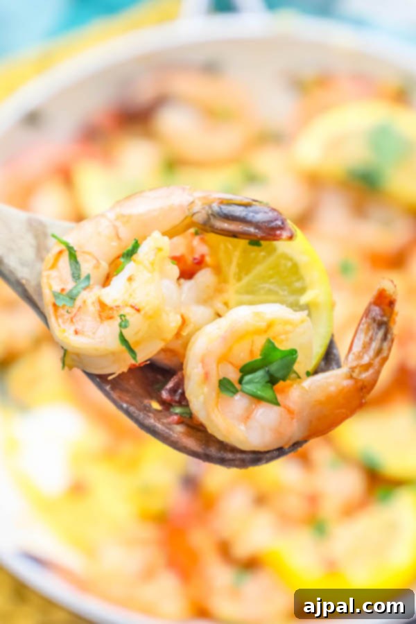Sizzling Lemon Garlic Shrimp 5 Close-up of a skillet filled with perfectly cooked lemon garlic shrimp.