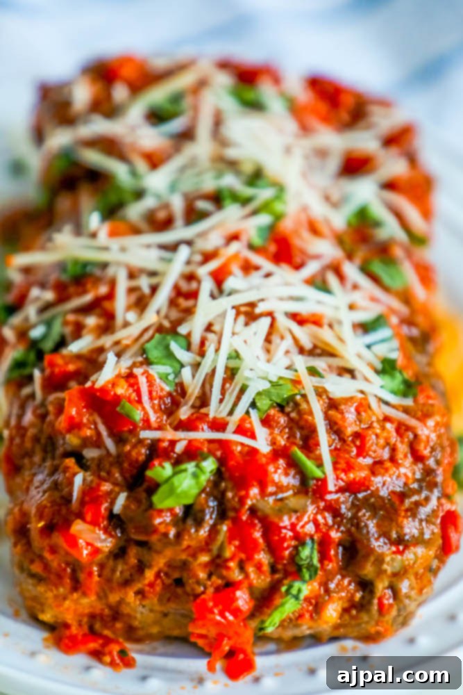 A perfectly portioned slice of gluten-free Italian meatloaf, rich with marinara and Parmesan cheese, ready to be served. This image emphasizes the recipe's success in creating a tender and flavorful meatloaf without gluten.