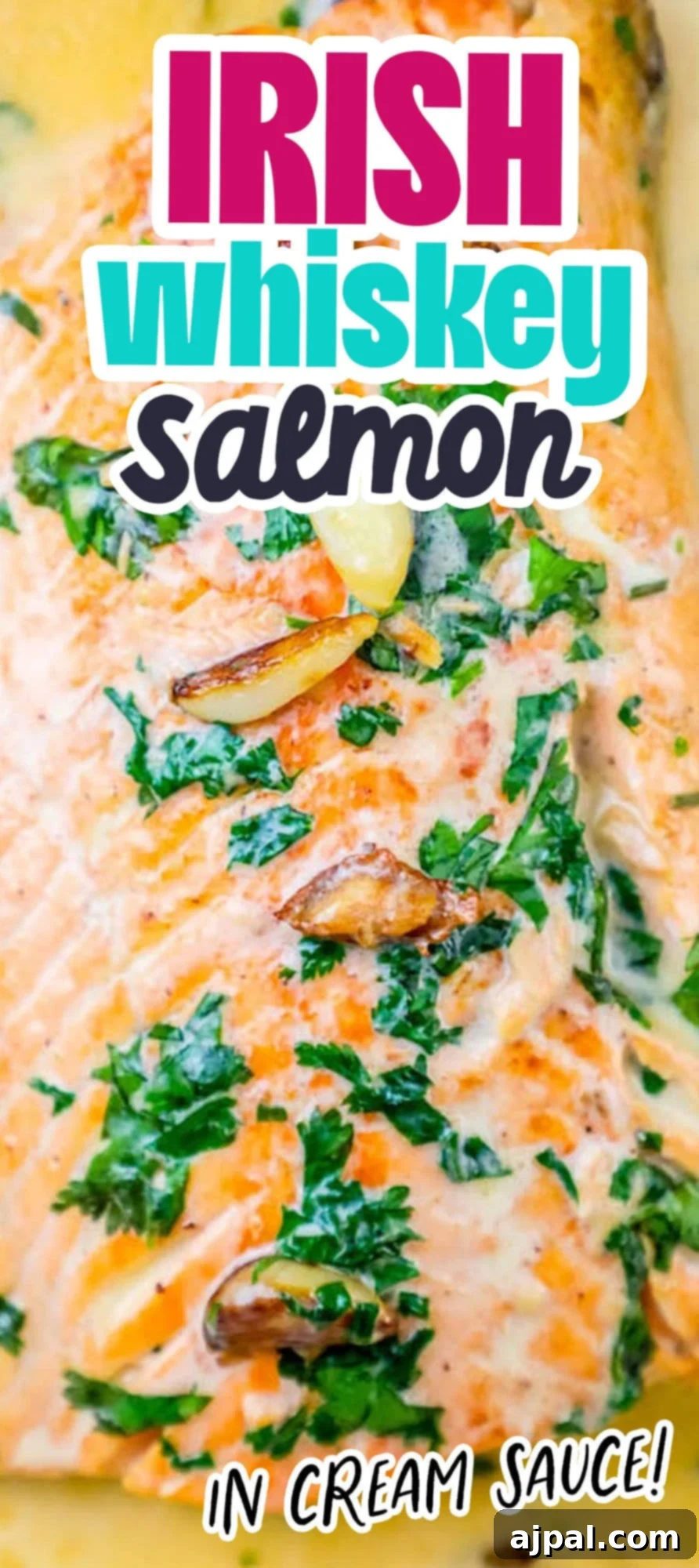 whiskey cream sauce salmon topped with chopped parsley and garlic cloves on top 
