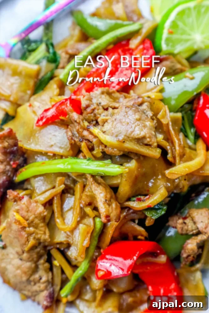 Effortless One Pot Beef Drunken Noodles 2 A vibrant bowl of Beef Drunken Noodles, showcasing tender beef, broad rice noodles, and fresh herbs, ready to be enjoyed.