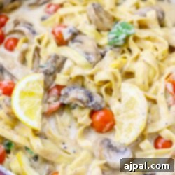 Silky One-Pot Tuscan Mushroom Linguine 9 Creamy fettuccine with mushrooms and tomatoes in a pan.