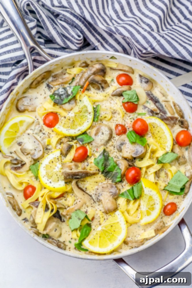 Silky One-Pot Tuscan Mushroom Linguine 5 A skillet full of creamy One Pot Tuscan Mushroom Linguine, with lemon slices and fresh basil.