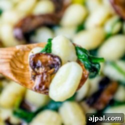 A creamy mushroom gnocchi with spinach.