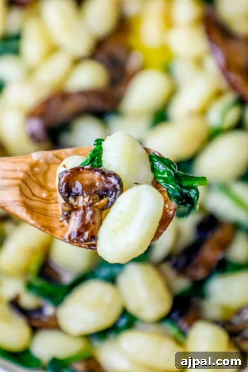 A creamy mushroom gnocchi with spinach.