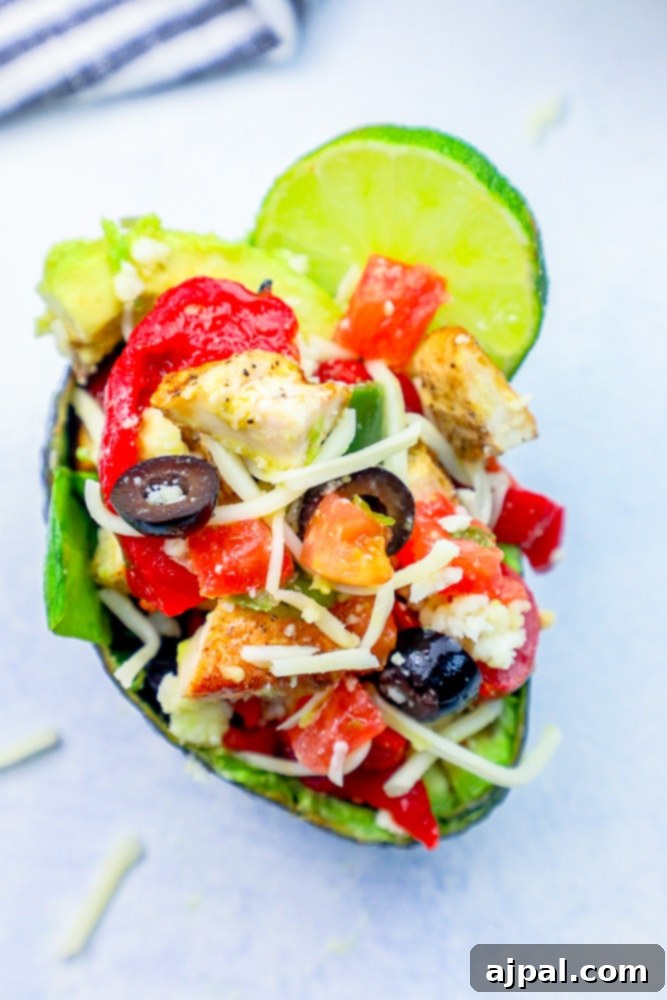 Loaded Cheesy Chicken Taco Salad Avocado Boats 2 avocado with chicken, olives, cheese in it