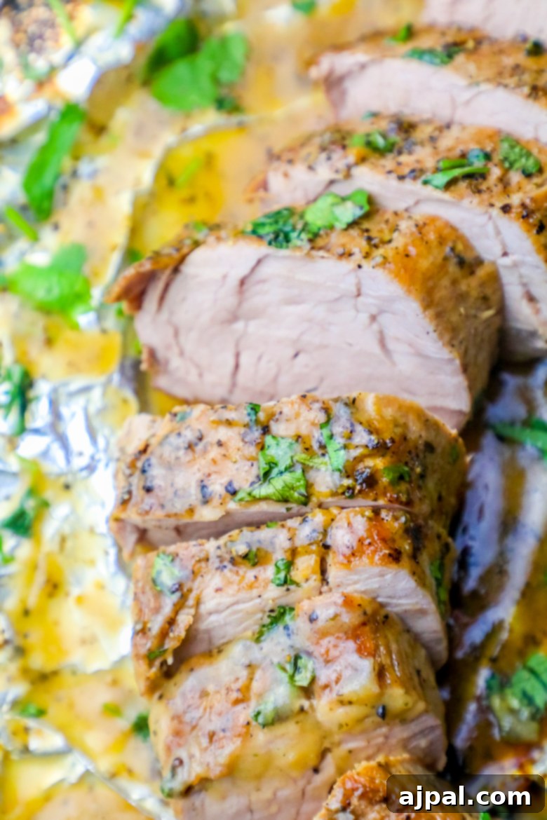 Simple Baked Ranch Pork Tenderloin with Gravy 6 Close-up of baked ranch pork tenderloin with cilantro and butter in foil.
