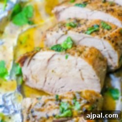 Simple Baked Ranch Pork Tenderloin with Gravy 9 Picture of pork tenderloin sliced and garnished with parsley on tinfoil.