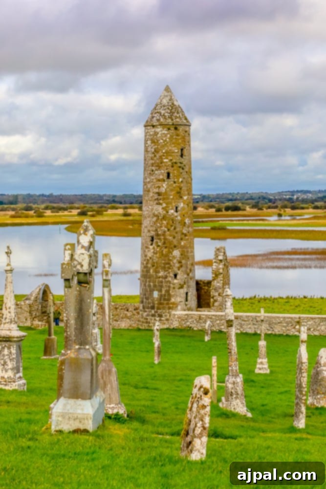 A cemetery with a tower situated in the grassy field of Ireland’s Midlands.