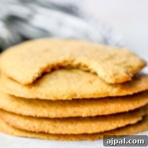 A stack of easy keto peanut butter cookies with a bite taken out of them.