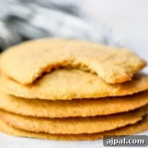 A stack of easy keto peanut butter cookies with a bite taken out of them.