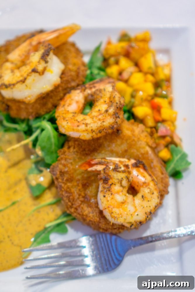 Savor Sanibel: A Culinary Journey 32 A plate of food with shrimp and a fork, perfect for dinner on Sanibel Island, Florida.