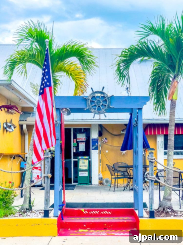 Savor Sanibel: A Culinary Journey 37 The entrance to a restaurant with palm trees serving dinner in Sanibel Island, Florida.