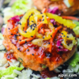 Sweet Chili Glazed Asian Salmon Burgers 6 Experience a spicy chicken patty topped with sliced pickles, shredded carrots, and black sesame seeds on a bed of chopped cabbage. It's almost as delightful as an easy salmon burger recipe but with its own fiery twist.