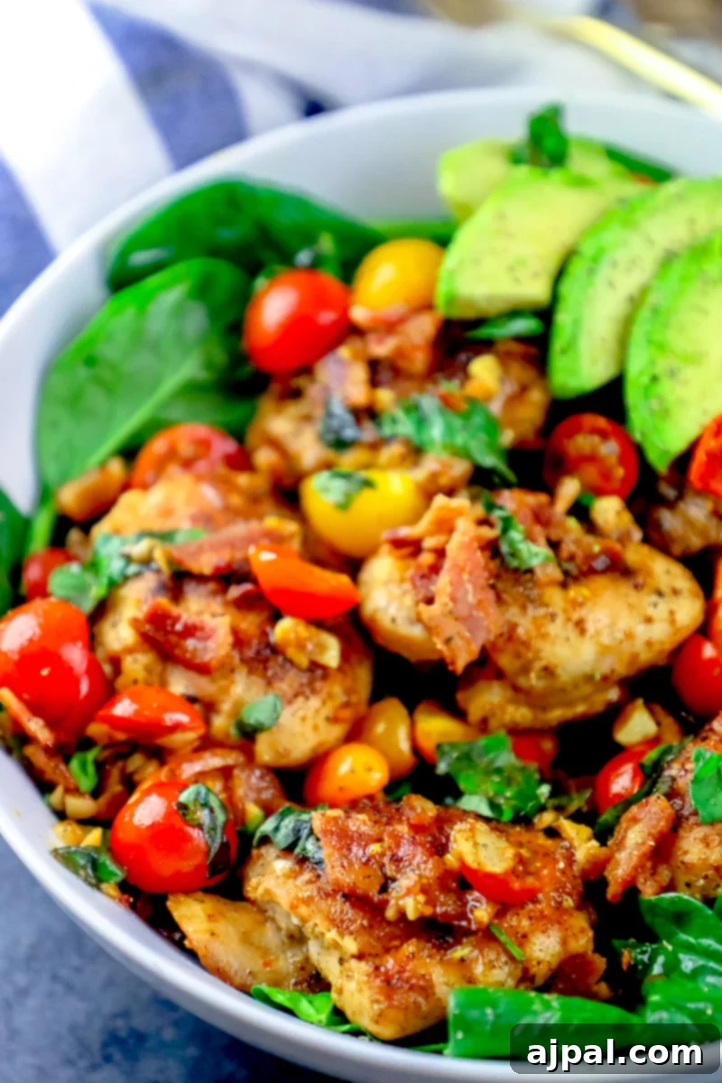 Ultimate B.L.A.T Chicken Thigh Salad 3 A picture of juicy chicken thighs on a bed of lettuce, bacon, tomato and avocado