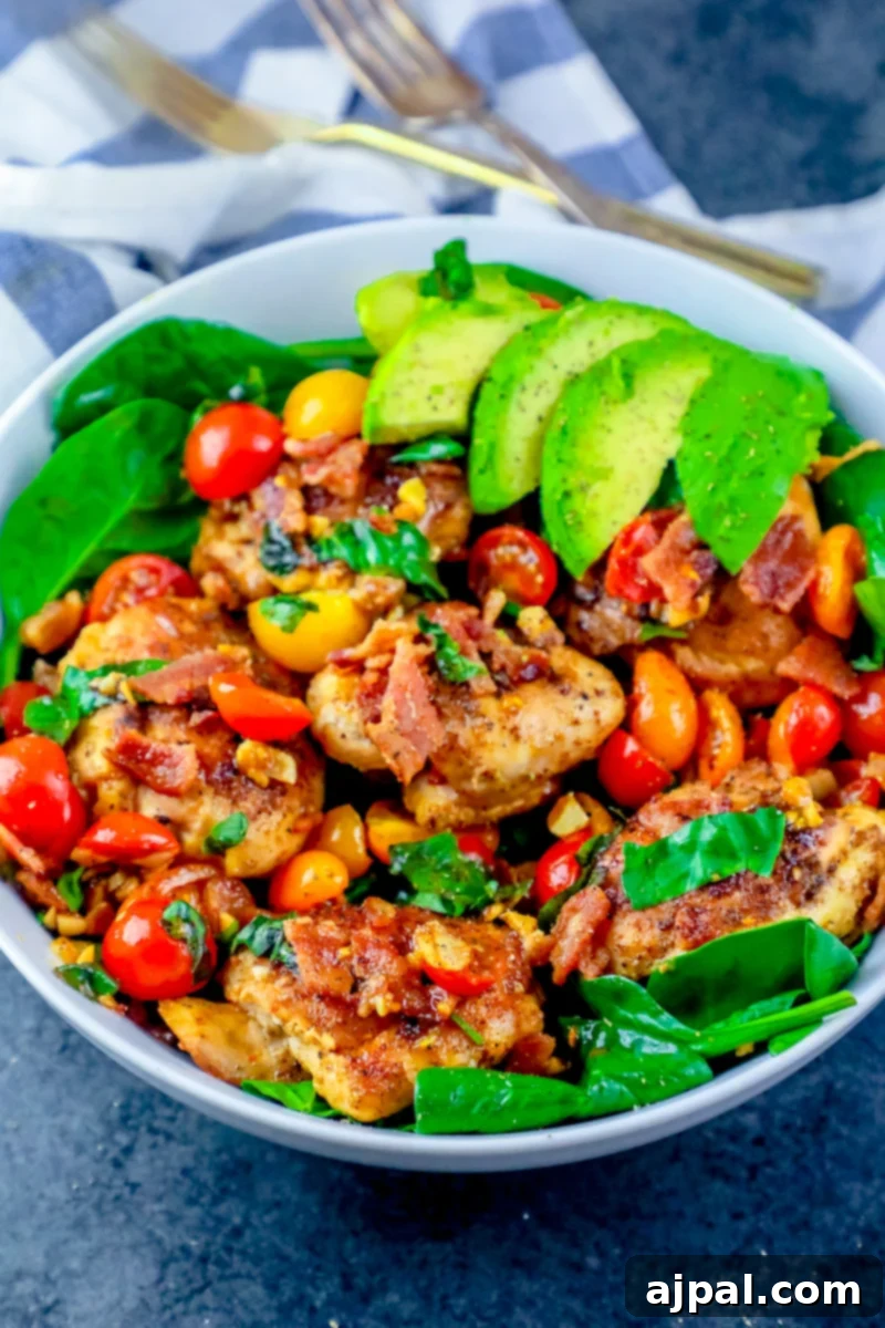 Ultimate B.L.A.T Chicken Thigh Salad 5 A picture of bacon, lettuce, avocado, tomato chicken thigh salad on a bowl