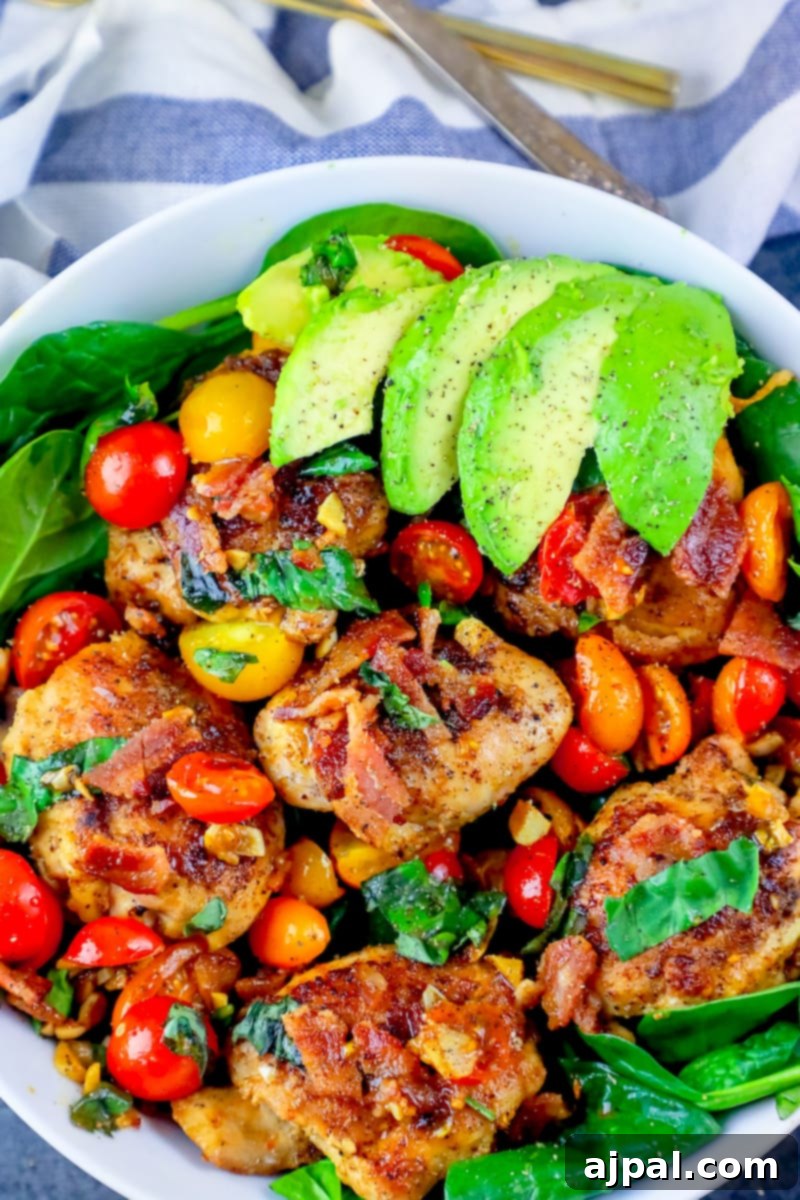 Ultimate B.L.A.T Chicken Thigh Salad 6 A picture of bacon, lettuce, avocado, tomato chicken thigh salad on a bowl