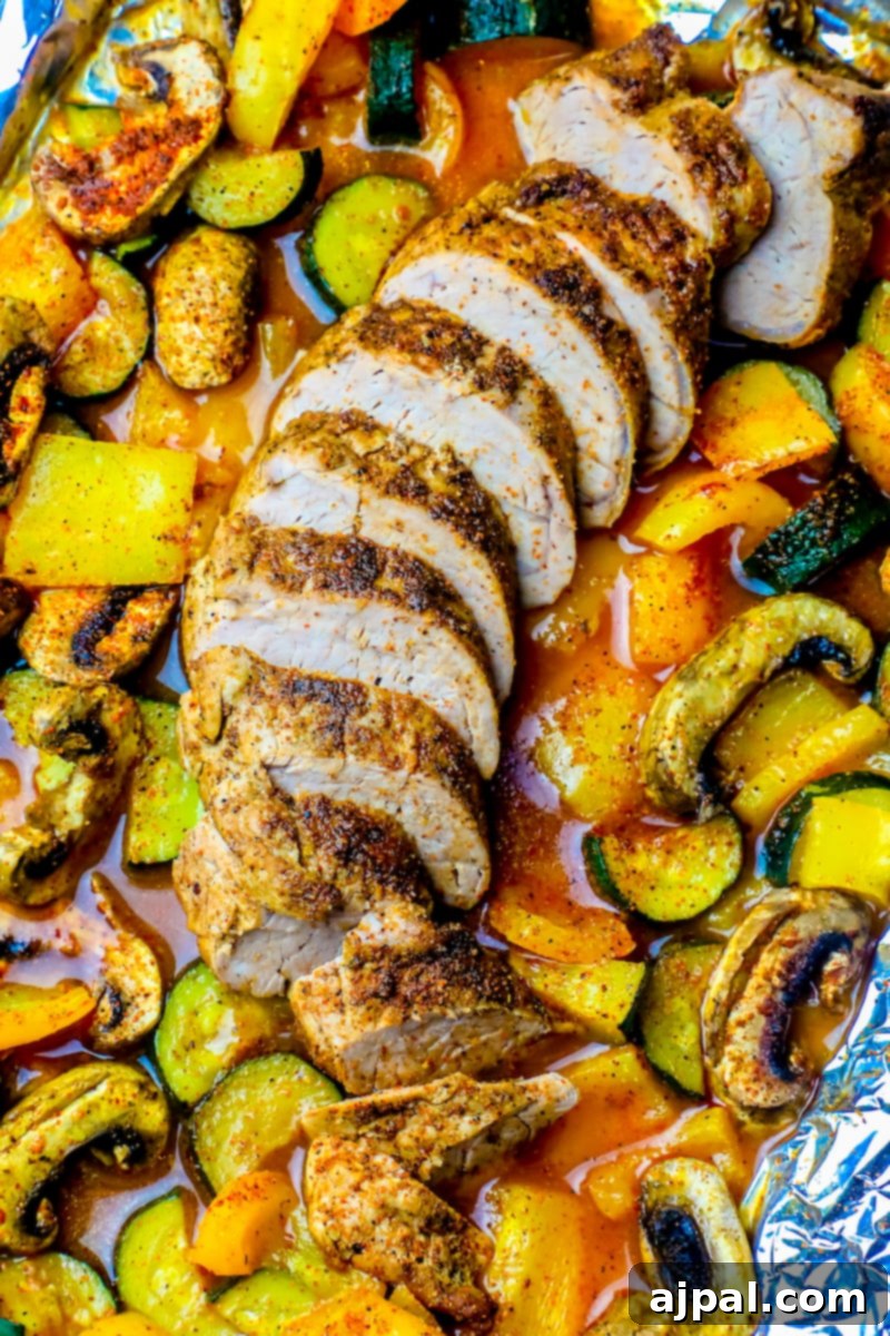A foil pouch with blackened pork tenderloin and vegetables.