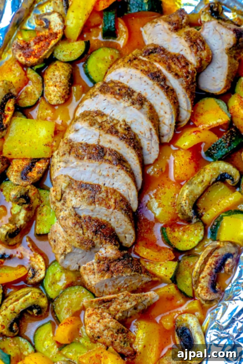 A foil pouch dinner with pork tenderloin and vegetables.