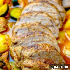 A plate with sliced pork tenderloin and vegetables on it.