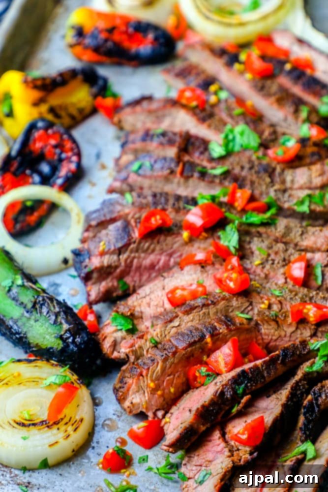 Ultimate Carne Asada 5 The Best Grilled Carne Asada Recipe Ever featuring a perfectly cooked steak with vibrant peppers and onions on a baking sheet, ideal for a low-carb keto meal.