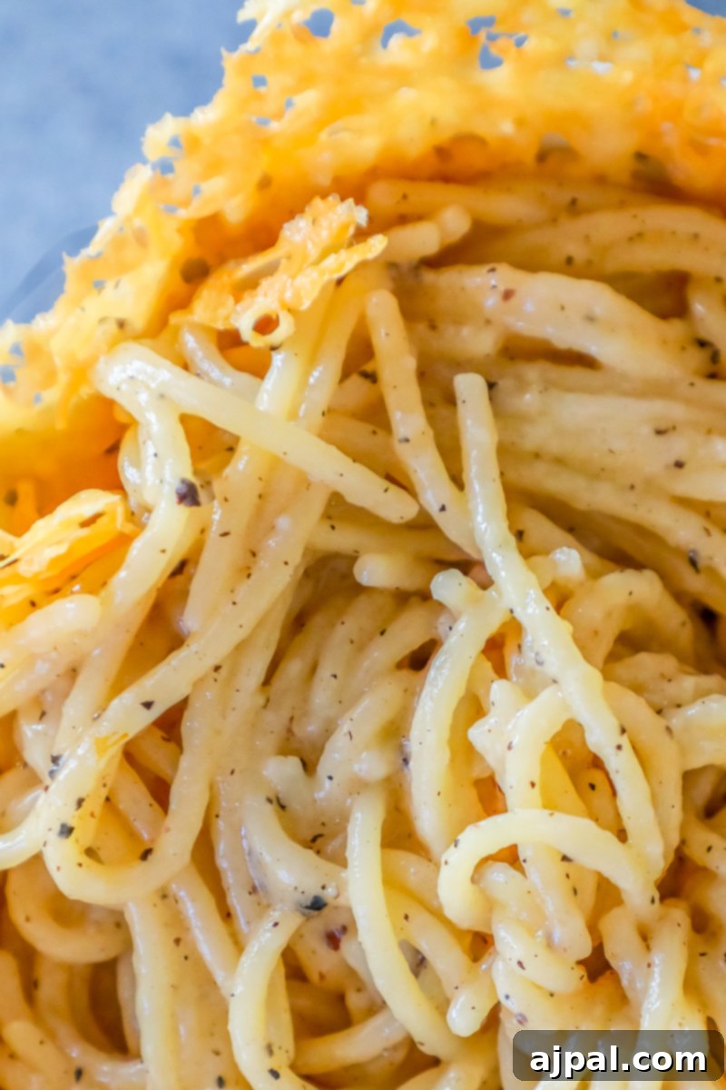 A close-up of The Best Easy Cacio E Pepe Recipe Ever, showcasing creamy pasta, cheese, and a sprinkle of fresh pepper, ready to be enjoyed.