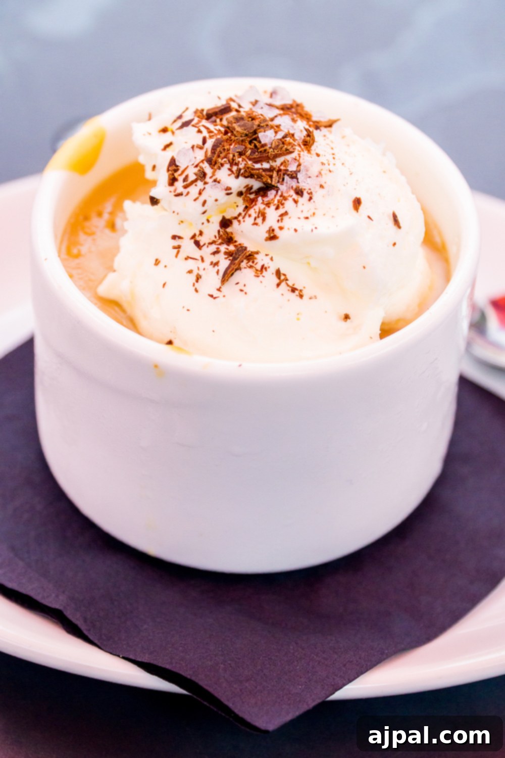 A white bowl with whipped cream and a spoon, found at the best restaurants in Kansas City.