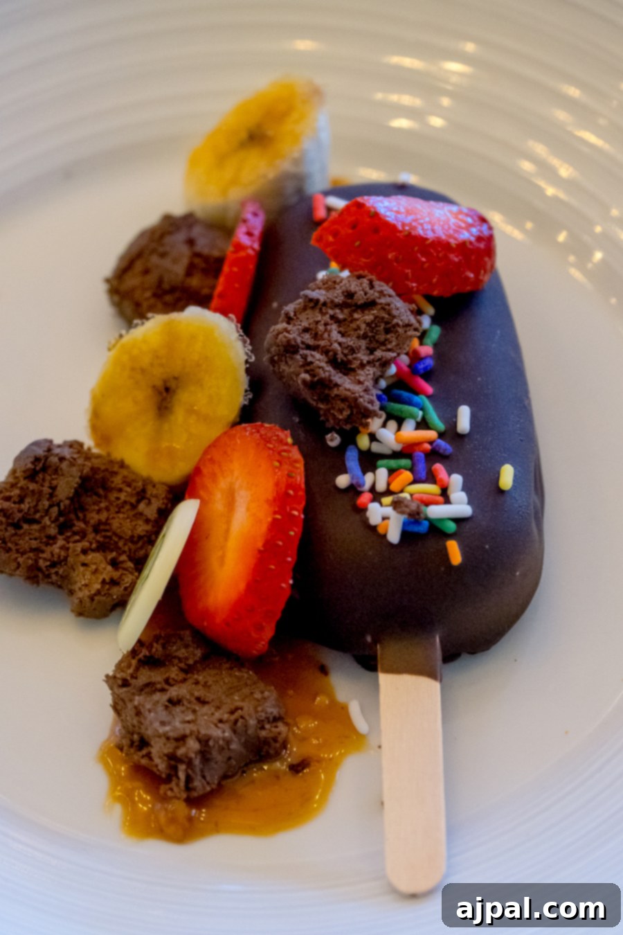 A delectable chocolate popsicle atop a pristine white plate, perfect for food enthusiasts exploring Kansas City.