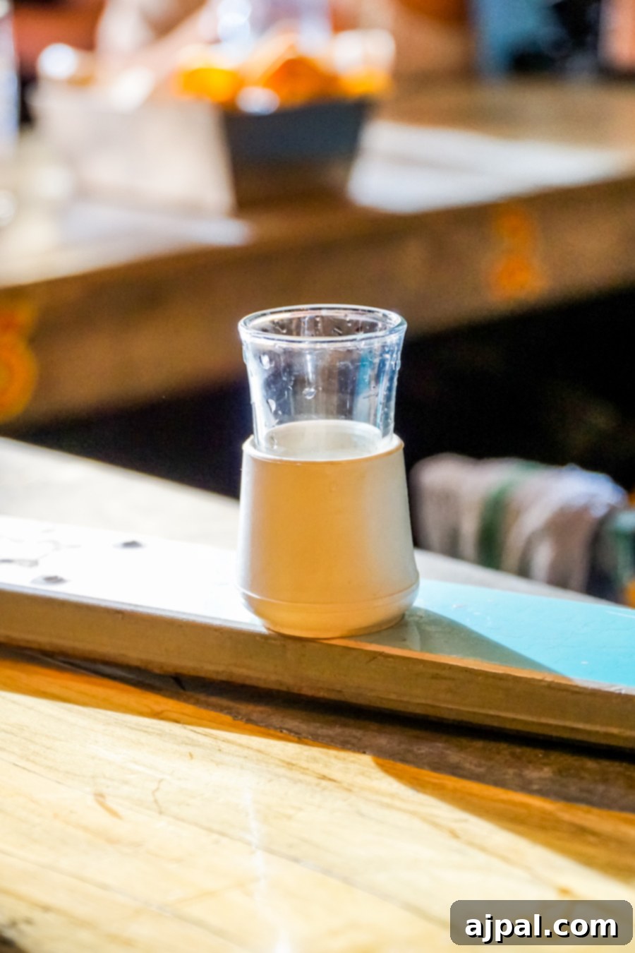 A shot glass resting on a wooden table in Kansas City Missouri.