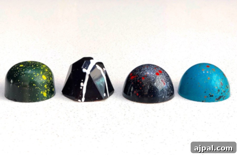 Five different colored chocolates with splatters on them are the perfect treat to enjoy while exploring the best restaurants in Kansas City during your vacation.