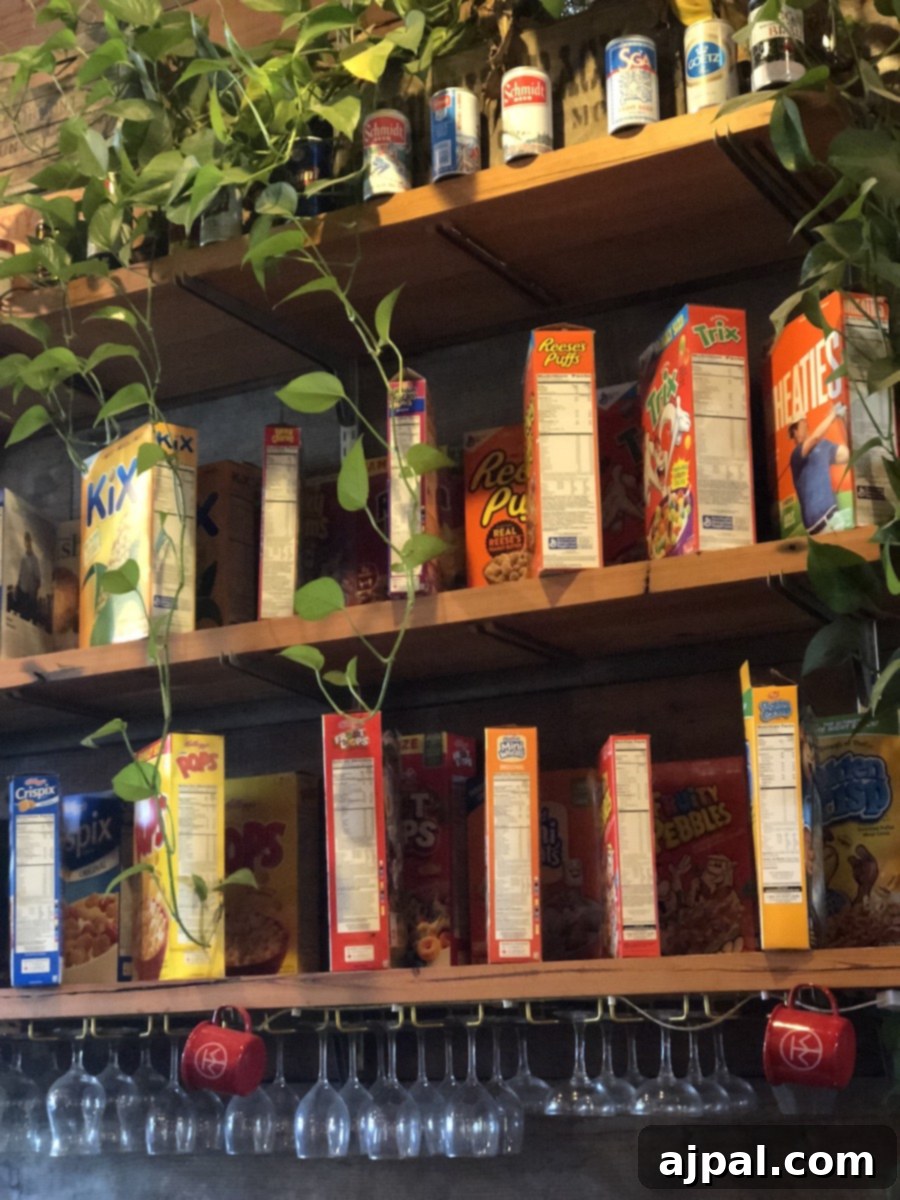 A selection of delicious food and beverages displayed on a shelf, including cereal and wine glasses, complemented by a vibrant plant.