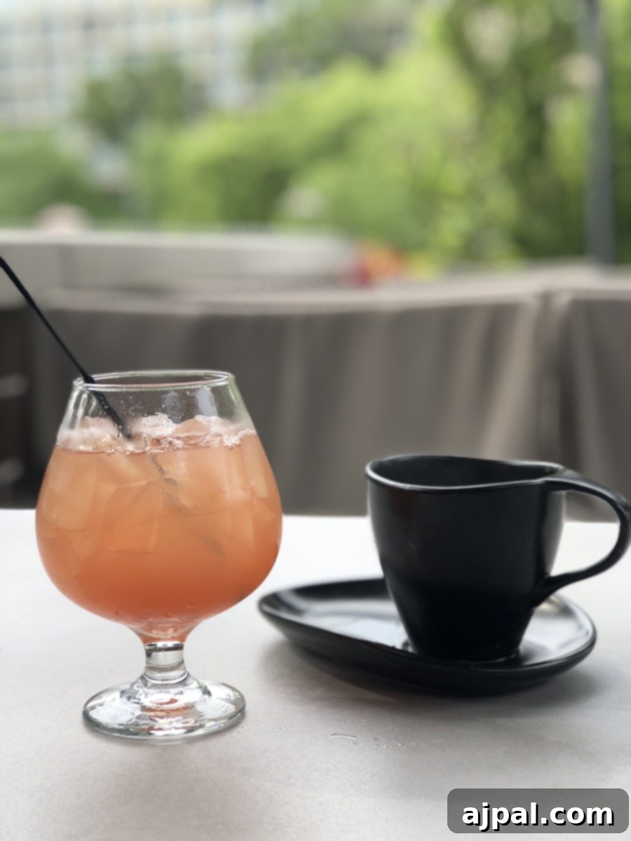 A refreshing drink with a straw and a cup on a table at one of the best restaurants to visit when vacationing in Kansas City.