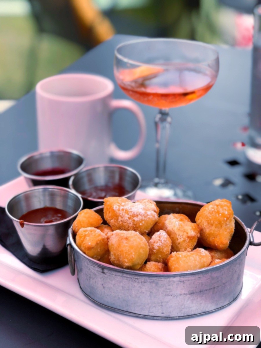 A selection of delicious donuts and a refreshing drink on a table at one of the best restaurants in Kansas City during your vacation.