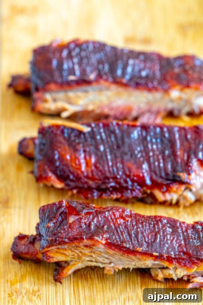 A mouthwatering display of smoked ribs on a rustic wooden cutting board, perfectly cooked and ready to serve.