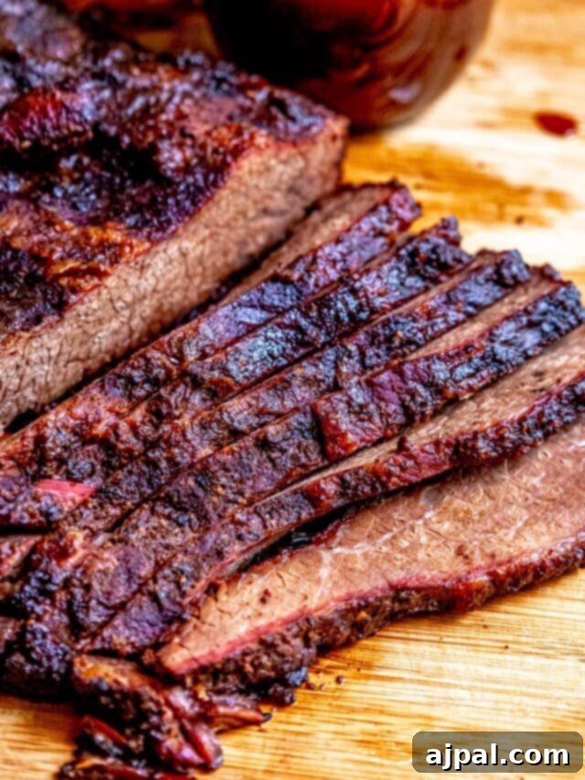 A vibrant, close-up shot of seasoned, uncooked brisket, ready for the smoker.