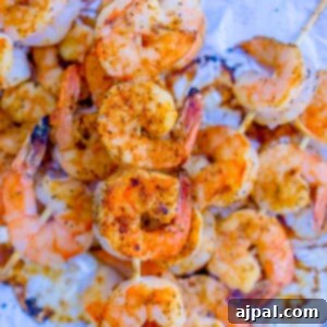 Quick Blackened Shrimp Skewers 6 Grilled shrimp kebabs on foil.