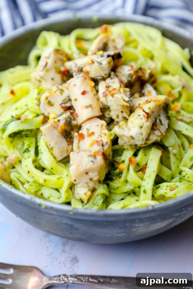 Vibrant chimichurri chicken pasta in a ceramic bowl, garnished with fresh herbs, ready to be served for a delicious dinner.