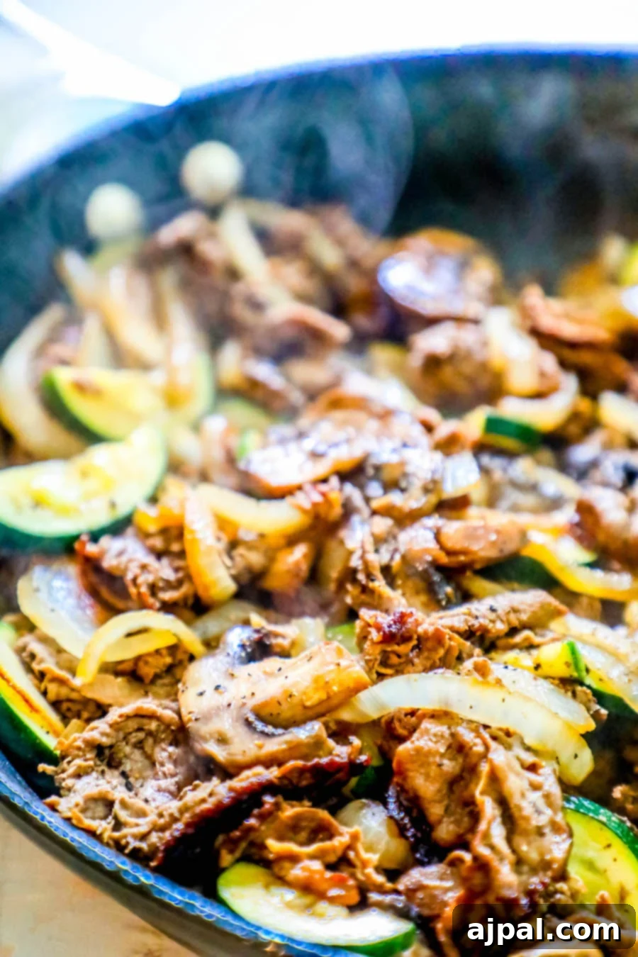 One-Pan Sirloin and Veggies Dinner 2 Sautéed beef with squash, mushrooms, and onions in a skillet