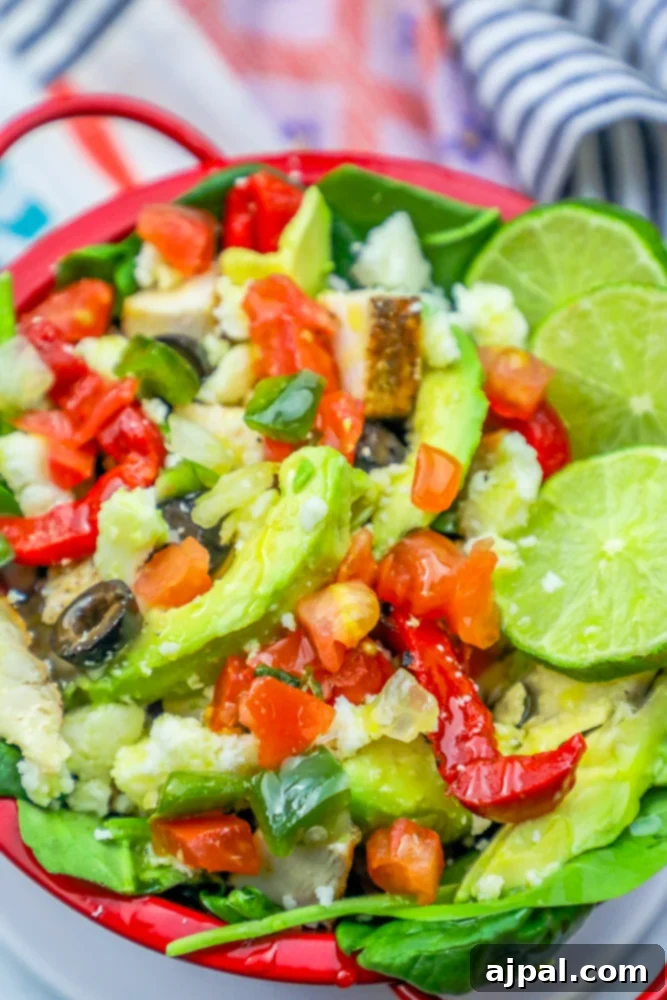 Quick and Delicious Chicken Taco Salad 6 A red bowl filled with a fresh chicken fajita salad, showcasing a delightful blend of colors and textures.