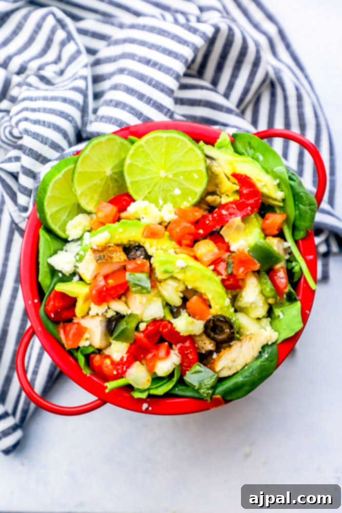 Quick and Delicious Chicken Taco Salad 5 A red bowl showcasing a beautifully arranged keto chicken taco salad, ready to be enjoyed.