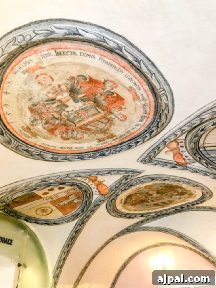 An ornate painted ceiling in a room at Krumlovská Pohádka, a charming hotel in Cesky Krumlov, Czechia, showcasing intricate historical design.