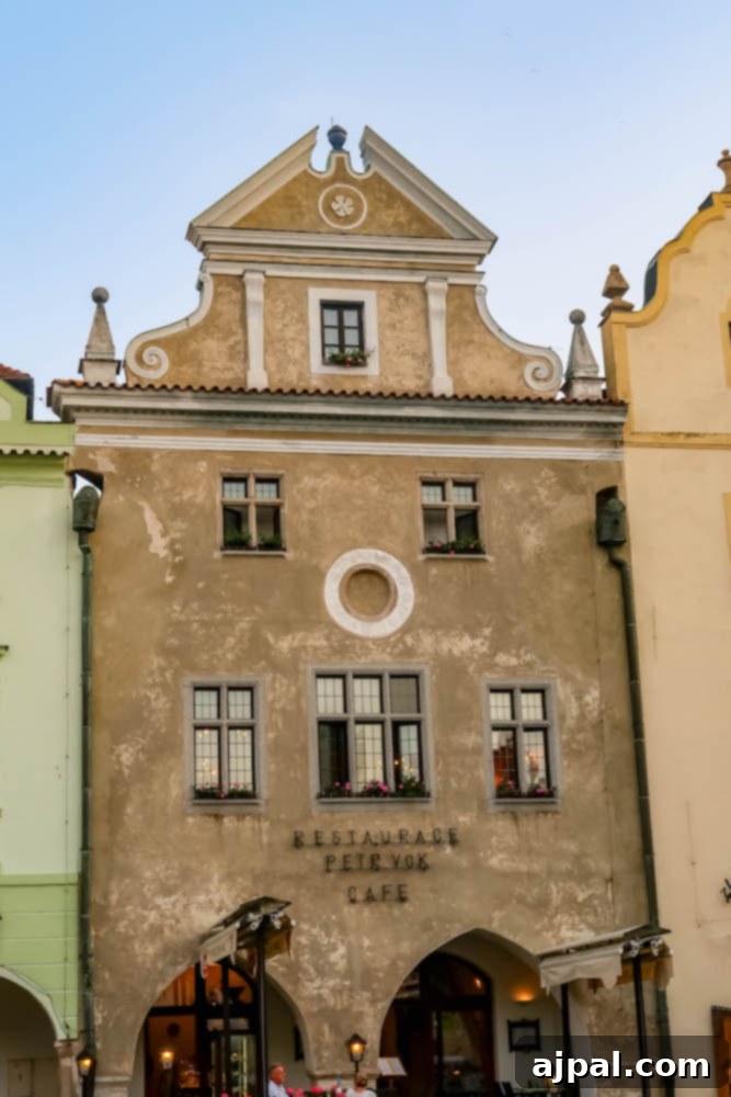 A picturesque old building in Cesky Krumlov, Czechia, showcasing medieval architecture with its colorful facade and unique windows.