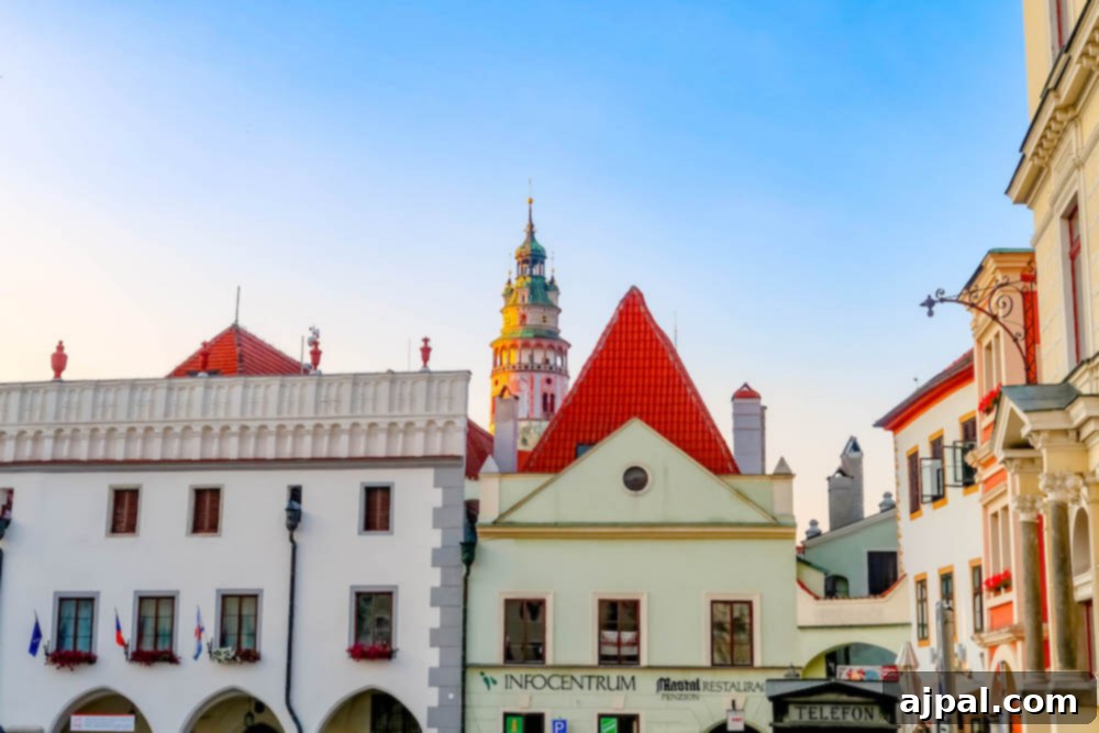 A panoramic view of Cesky Krumlov's vibrant town square, bustling with people and surrounded by colorful historic buildings.