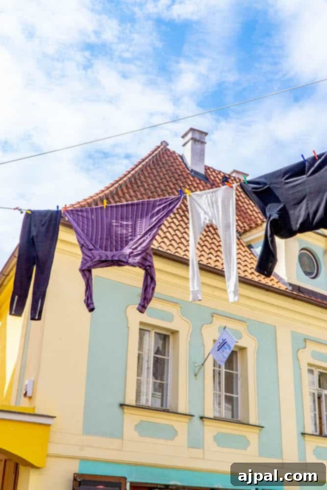 Laundry hanging to dry outside colorful historic buildings in a charming street of Cesky Krumlov, adding to the town's authentic atmosphere.