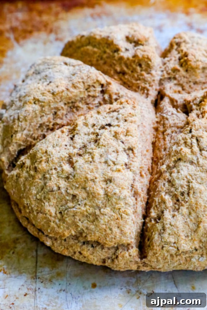 Beautifully sliced Irish Brown Soda Bread on a wooden cutting board, ready for serving with butter.