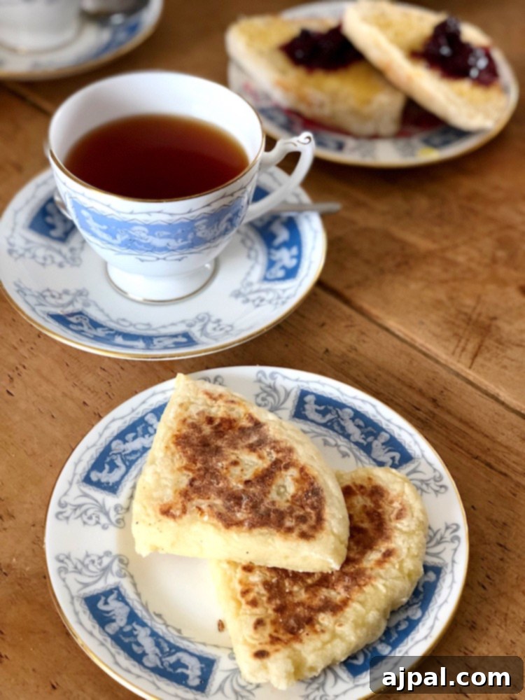 Two pieces of golden-brown Irish Soda Bread served with a comforting cup of tea on a rustic wooden table.