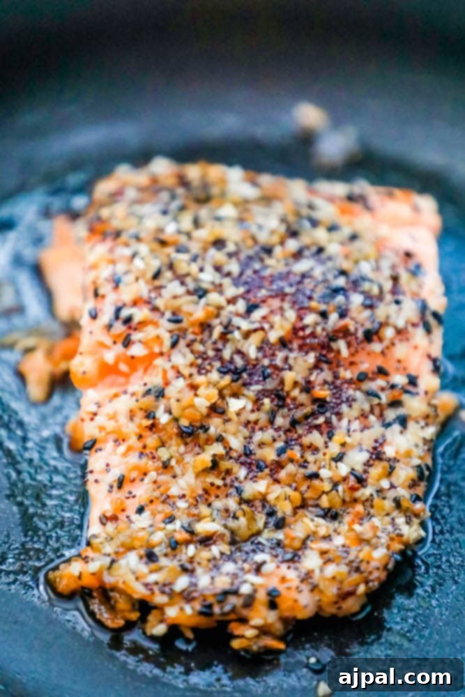 Cooked Everything Bagel Salmon fillet resting in a pan, showcasing its perfect golden crust.