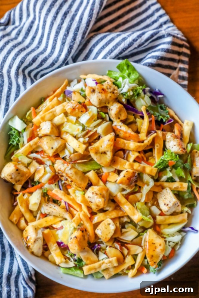 A vibrant chopped Chinese chicken salad in a white bowl, ready to be enjoyed.