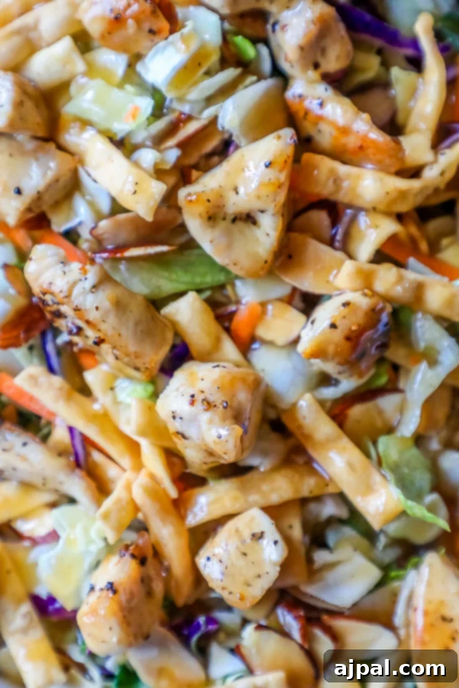 Close-up of a delightful Asian chicken salad, highlighting the tender chicken and crisp vegetables.